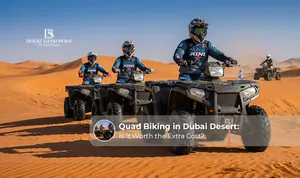 Tourists riding quad bikes across the Dubai desert sand dunes